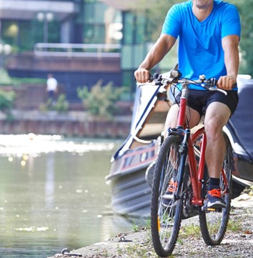 Cycling along the canal towpath in an urban setting